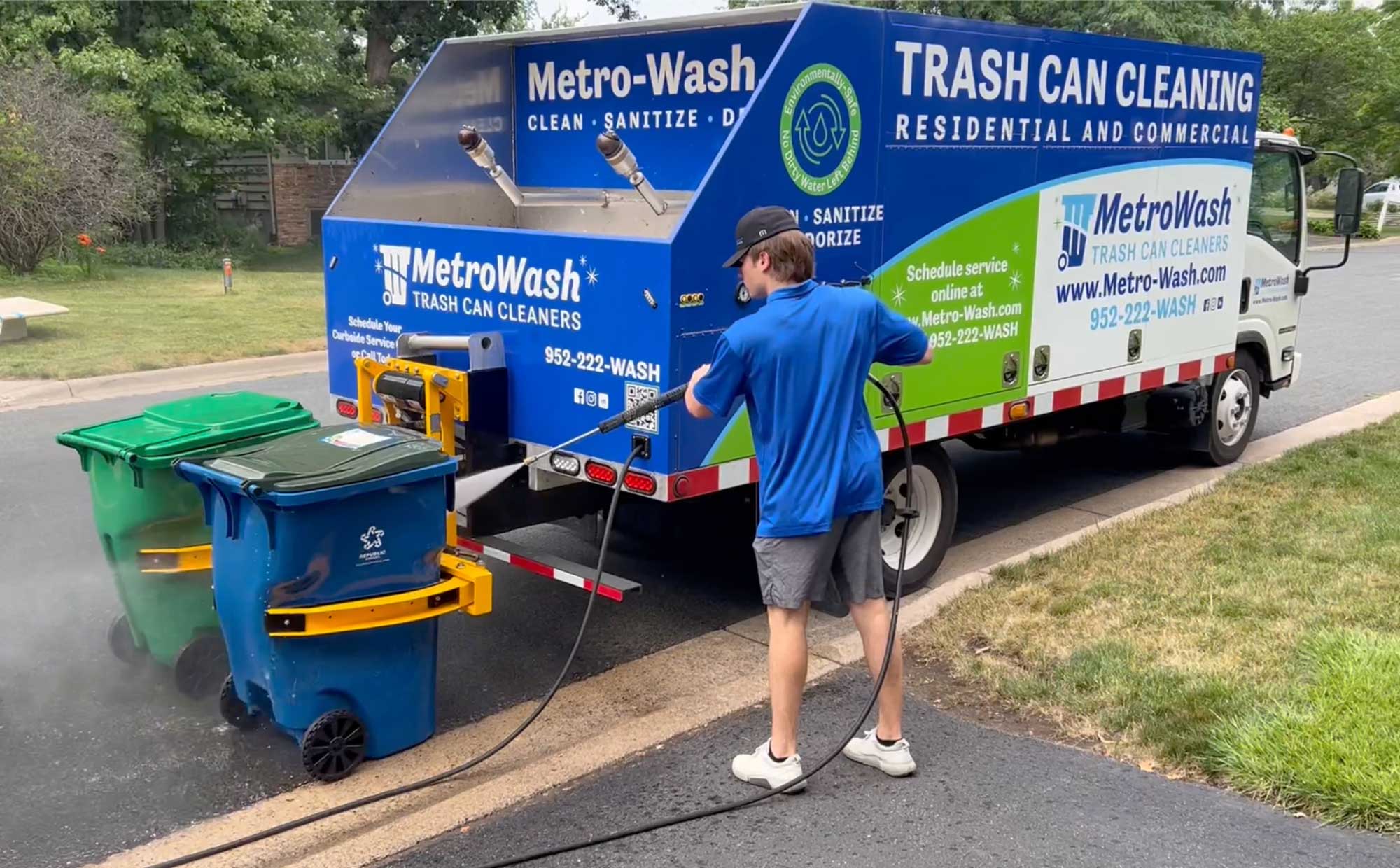 MetroWash truck performing curbside trash can cleaning with hot water sanitizing